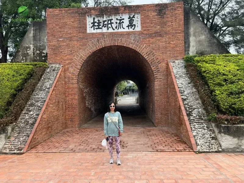 Walking through the brick tunnel of the historic Eternal Golden Castle in Tainan.
